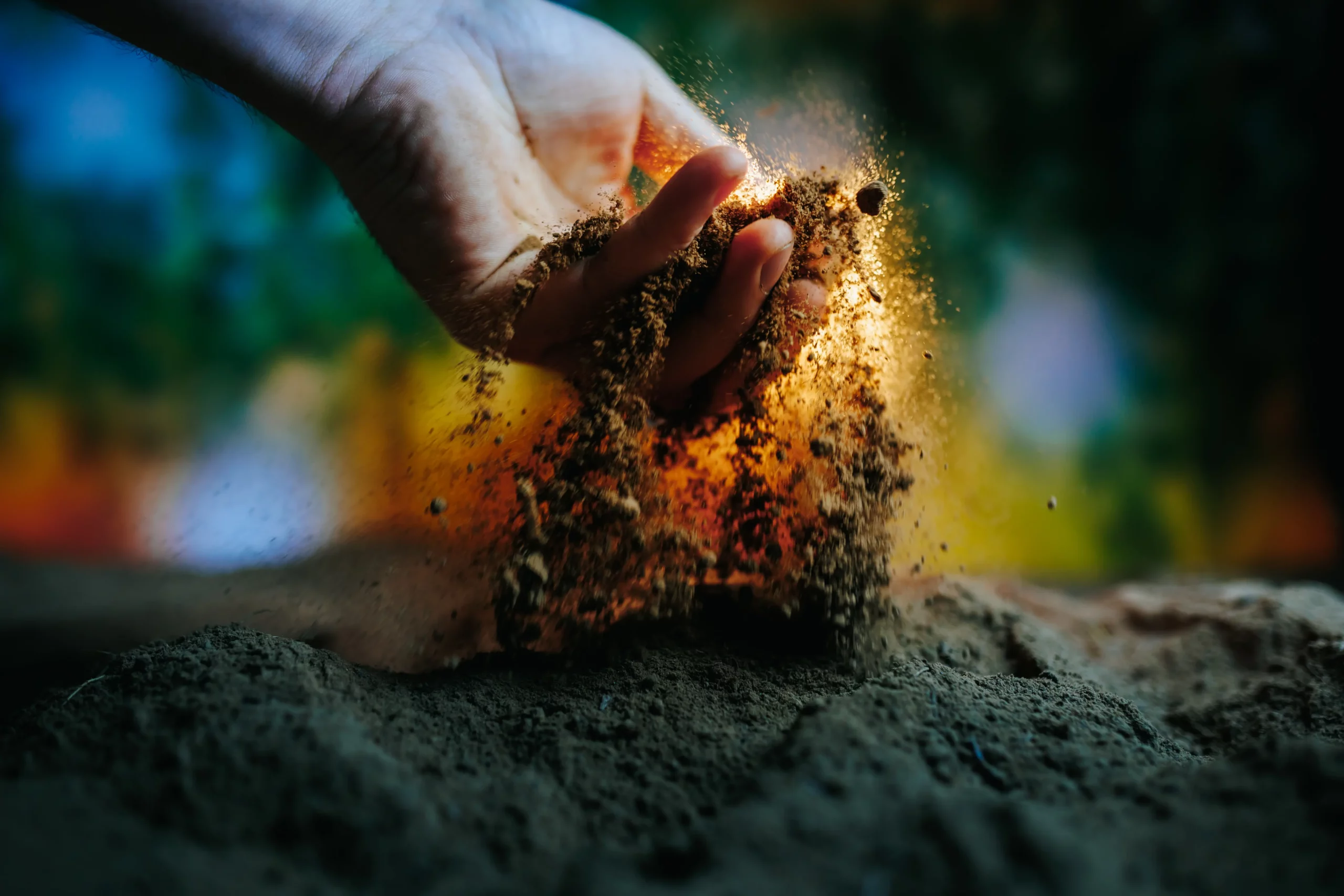 Hand picking up soil