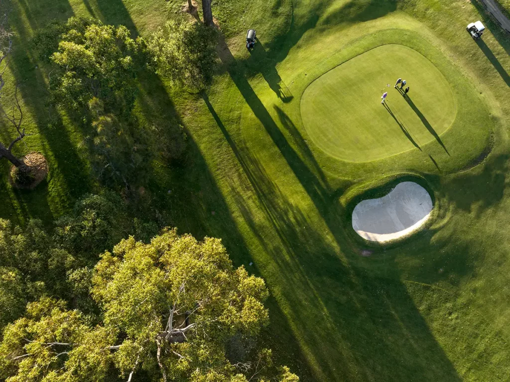 Golf course with tree-lined fairways